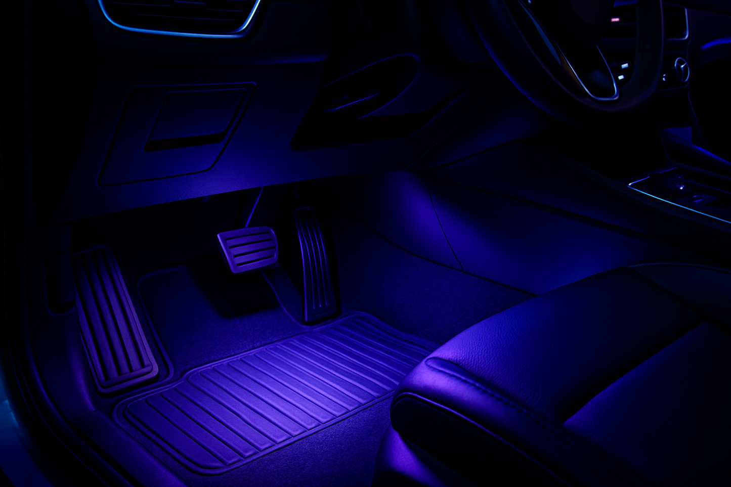 the inside of a car, the footwells illuminated by LED lights shining down, make it look techy and futuristic and cool